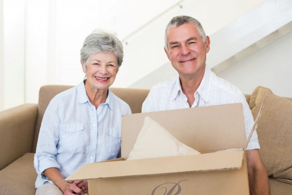 Mature couple with moving boxes