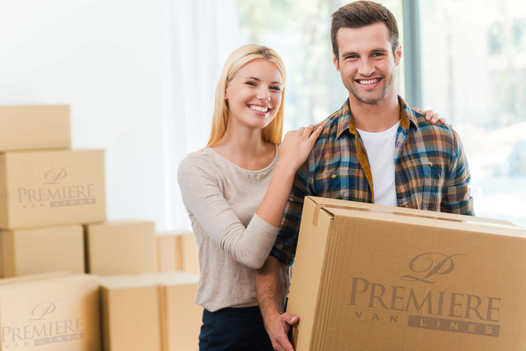 Two people holding boxes