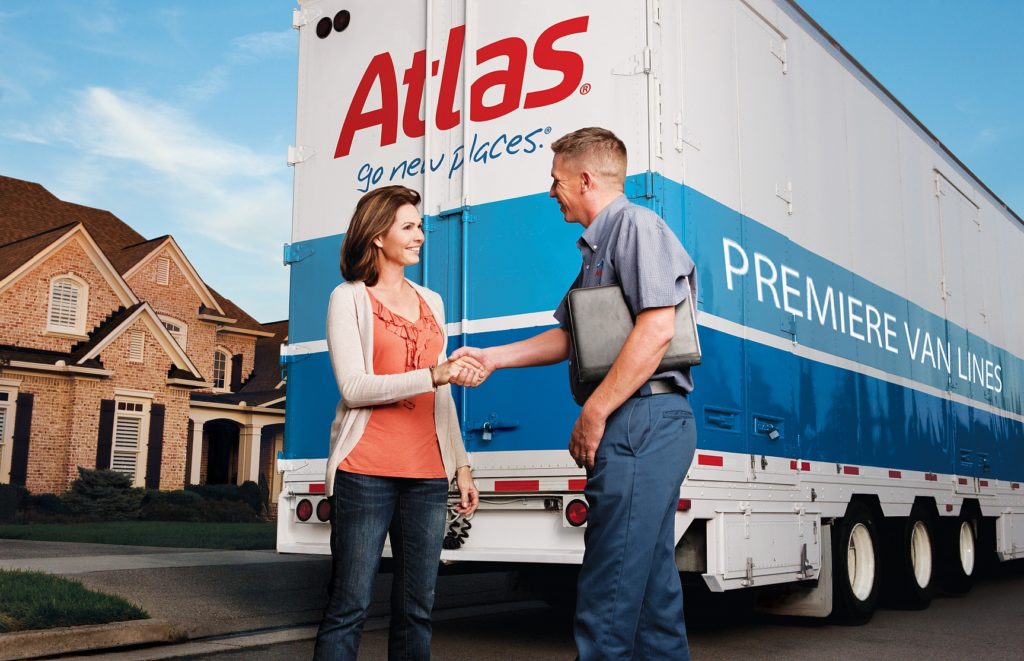 Two people in front of moving truck