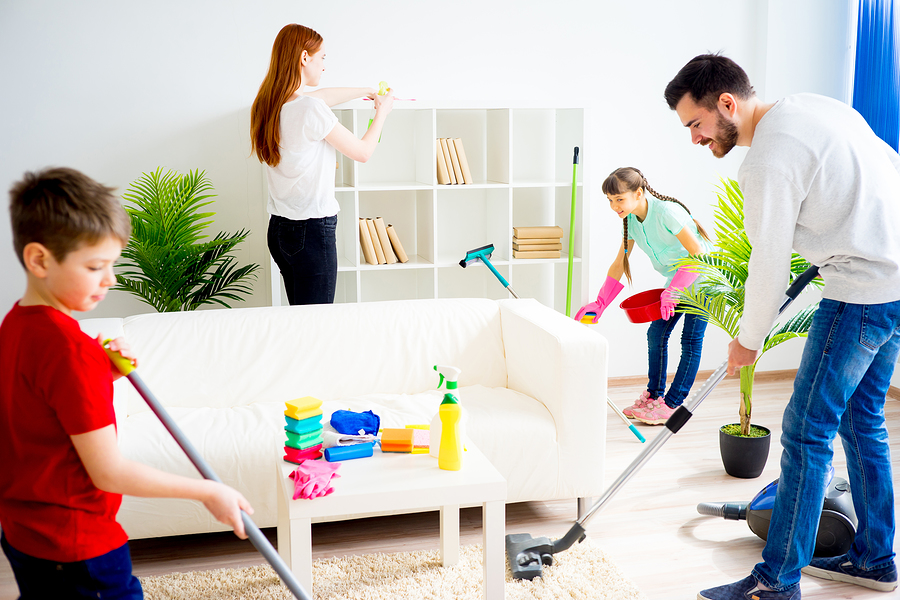 Family of four cleaning house